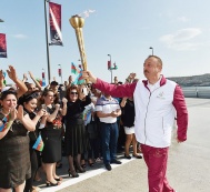  President Ilham Aliyev takes up the torch of Baku-2015 First European Games at “SADKO” Port in the Seaside National Park